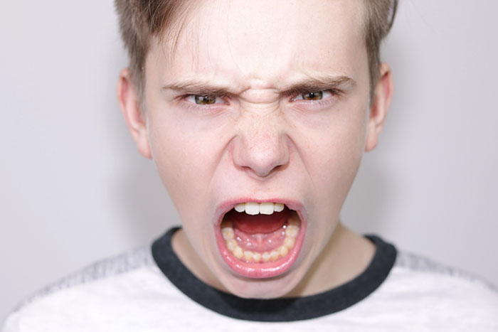 Teen yelling during an emotional outburst