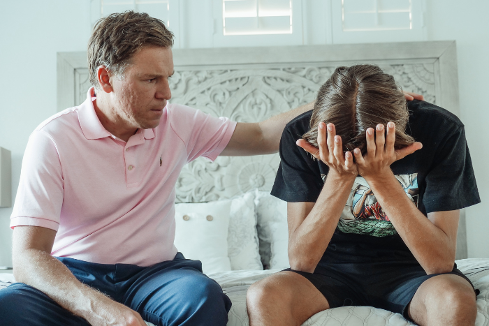 A father comforts his son after a suicide attempt. Embrace U offers mental health treatment to teens and pre-teens who think about suicide.
