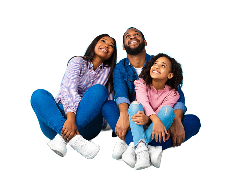 Family sitting together on the floor with heads tilted back and smiling