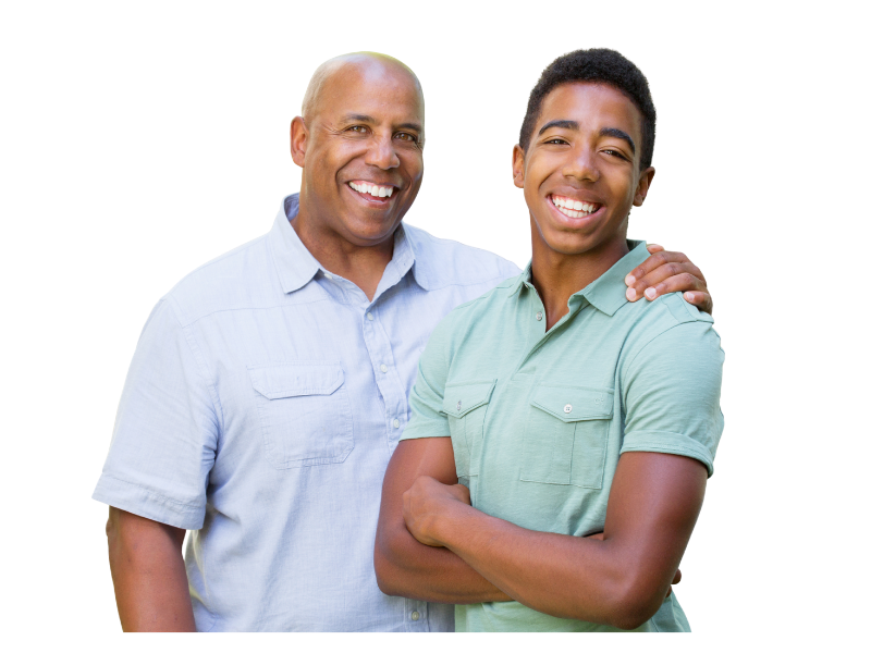 A father and teenage son smile at the camera.