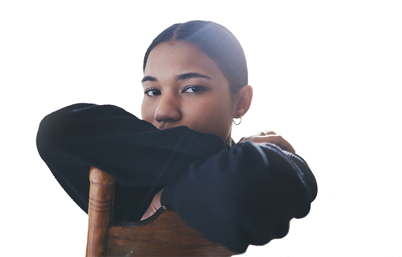 Young girl with anxiety sitting on a wooden chair