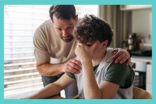 teen with anxiety worried with his dad consoling him